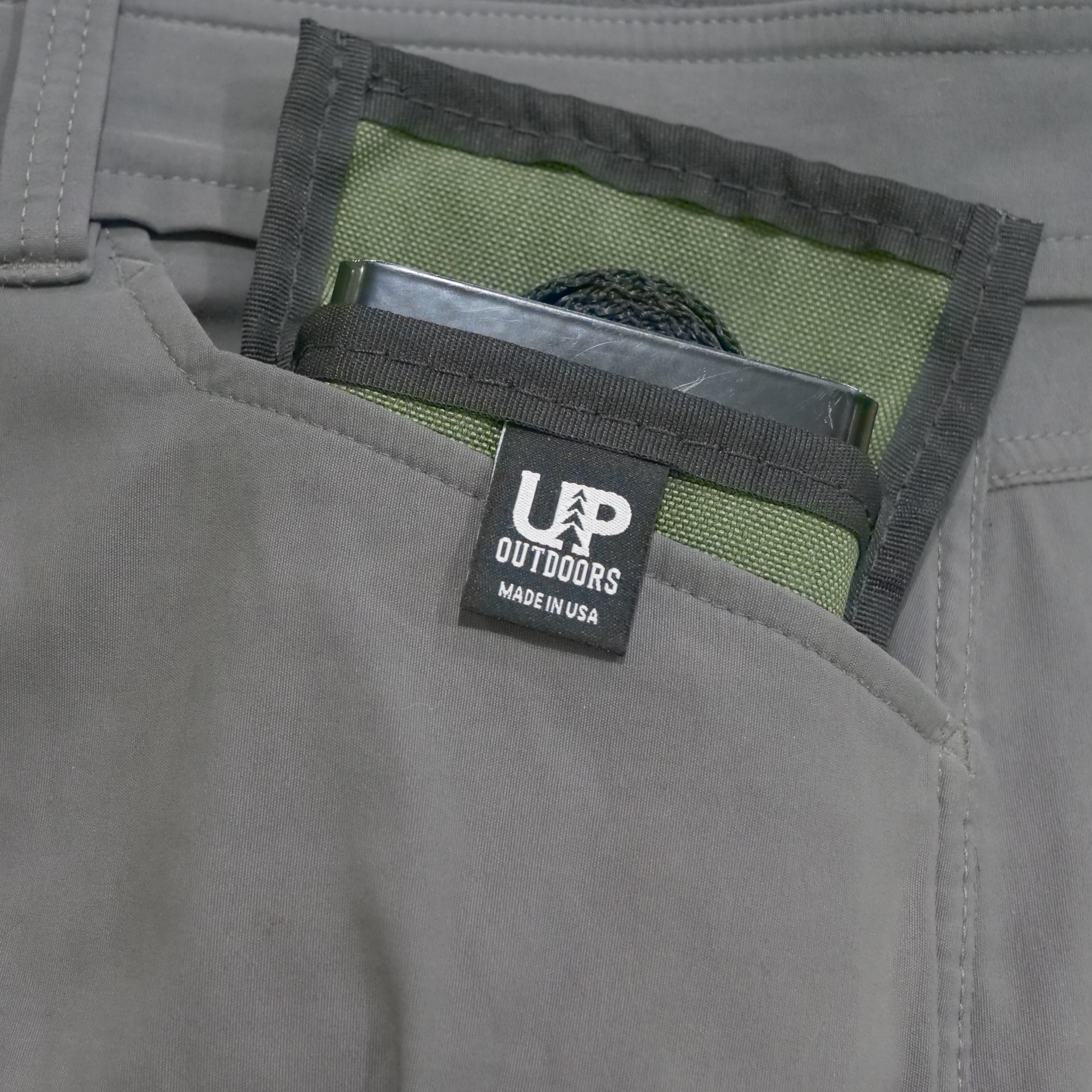 Top Shelf outdoor and camp table bracket fitting inside a pants pocket.