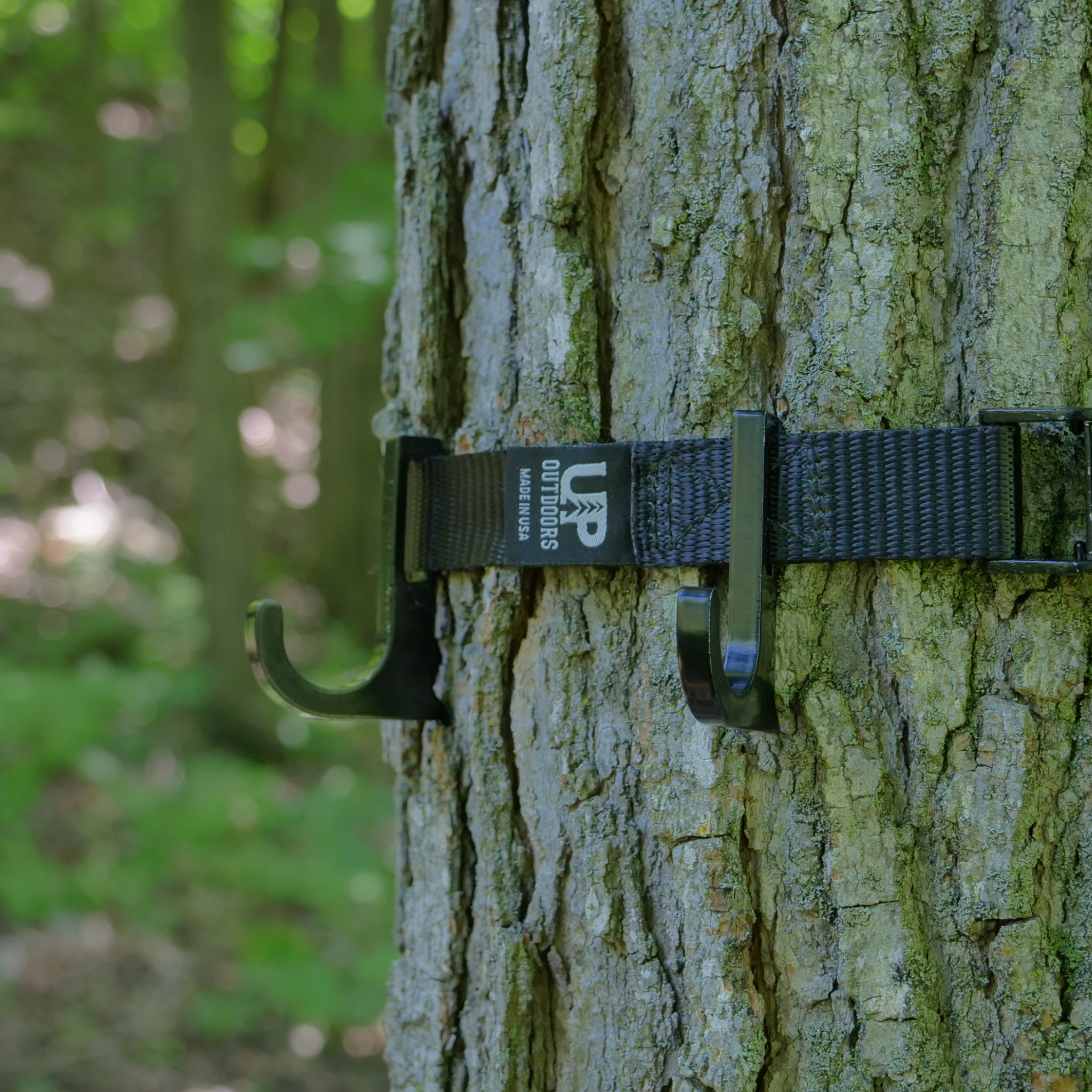 Top Shelf utility hooks secured to a tree with a Top Shelf cam buckle strap.